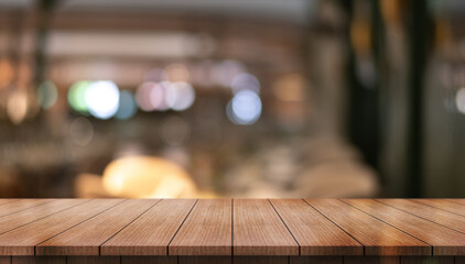 	
Empty wooden table top with lights bokeh on blur restaurant background.	
