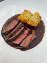 Beef steak on mole sauce and sweet potato