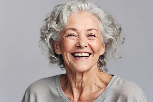 a closeup photo portrait of a beautiful elderly senior model woman with grey hair laughing and smiling with clean teeth. isolated on white background high quality image 
