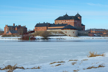 Obraz premium View of the Hameenlinna prison fortress from the shore of the lake. Finland