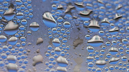 Droplets on window caused by condensation, macro perspective of bubbles on glass surface