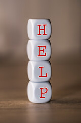 White dice with letters forming the word help