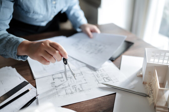 Interior Architect Or Engineer Working On Blueprint At Home Office