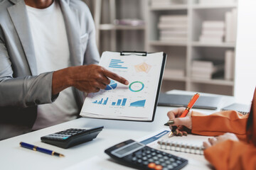 Teamwork process. Business people pointing at business document during discussion at meeting.