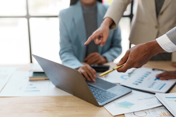 Business representatives meeting pointing on laptop computer. Business team discussing investment...