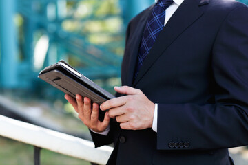 Close up of the hands of the businessman with a tablet PC