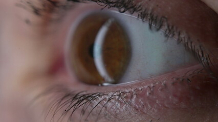 Macro close-up of woman's eyeball, tight extreme closeup of iris eye