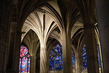 Naklejka premium Beautiful stained glass windows with colorful biblical scenes, inside a Parisian church.