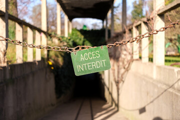 A chain cuts the access, with a sign in phrases that say 