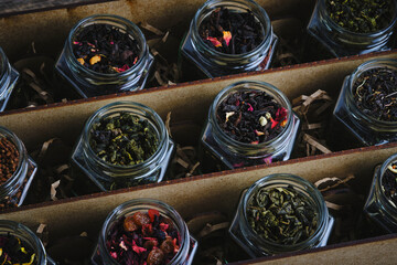 Set of various leaf tea packaged in jars. Black and green healthy tea with fruits, berries and herbs.