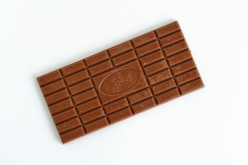 Bar of milk chocolate white background.