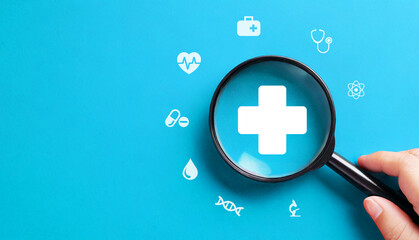 Health insurance concept with magnifying glass on blue background - obrazy, fototapety, plakaty