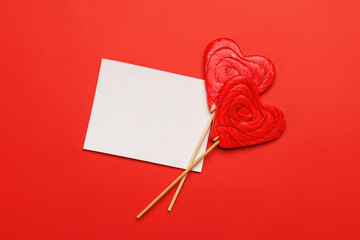 Heart lollipops: Sweet treats on a red backdrop with text space