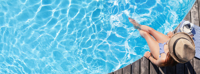 Woman on wooden deck near swimming pool - obrazy, fototapety, plakaty