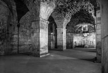 Fototapeta premium Old stone ruins inside. Stone halls and rooms of an old palace or dungeon.