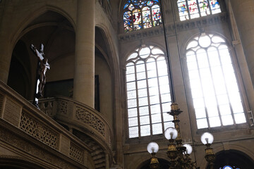Paris, France - December 31, 2023: Interior of a church, with sun rays illuminating the Christian...
