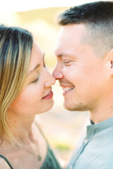 Young woman almost kisses smiling man. Portrait