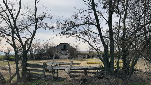 Old abandoned ranch and vintage barn in field