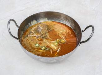 Beef nihari or nihaari gosht served in karahi isolated on grey background side view of pakistani and indian spices food