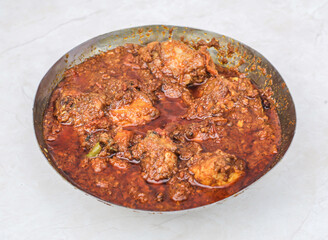 Spicy Chicken karahi korma masala with gravy served in karahi isolated on grey background side view of pakistani and indian spices food