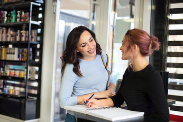 Cute woman welcomes customer and register in a health and beauty spa