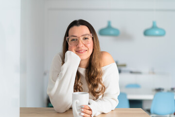 Smiling Woman Enjoying a Cozy Coffee Break at Home