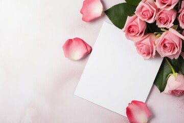 White card with flowers nearby on a pink background for valentine's day or wedding anniversary with copy space for text