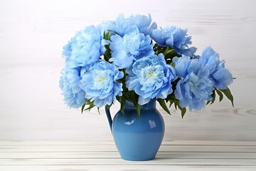 Blue peony flowers in vase on wooden background