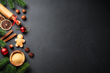 Christmas food and ingredients for cooking at black. Gingerbread cookies, spices and Christmas...