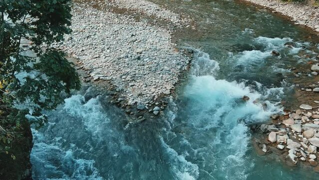 The Bolshaya Laba River. A mountain emerald river in a narrow, sunlit canyon. Bolshaya Laba River near the village of Psemen in Karachay-Cherkessia, Russia. Panoramic view. 4K