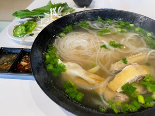 a bowl of pho ga - vietnamese chicken pho, rice noodle soup with chicken