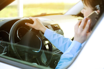 Close up confident business woman talking on mobile phone with clients behind steering wheel...