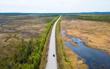 Fotobehang Road leading through wetland of finnish Lapland above the arctic circle © Photofex