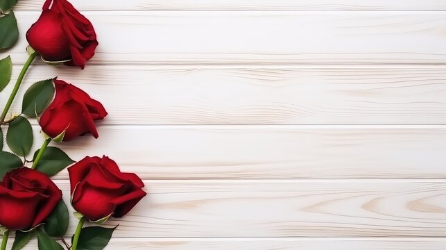 Red roses on white wooden background.