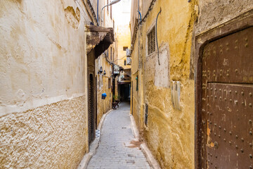 Fes, Morocco. View of the narrow and suggestive alleys in the ancient souk of the medina in Fes in...