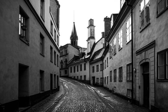 a cobbled street between buildings