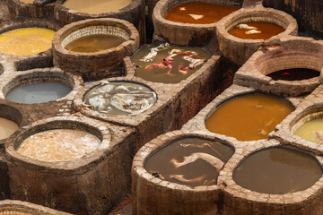 Old tanks of the Fez tanneries with color paint for leather, Morocco.