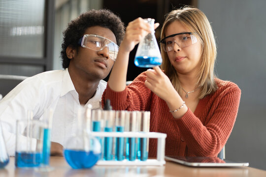 Multi-Cultural Children teenage. Education: Group of teenage doing the activity in science classroom. Group of friends studying. Group portrait diverse teenage boy and girls.