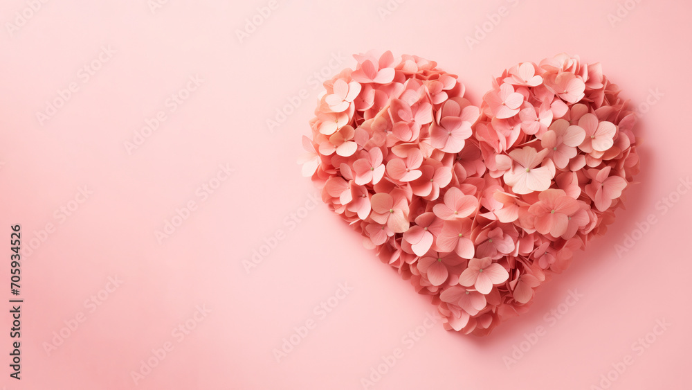 Wall mural A heart shape made of delicate pink hydrangea petals on a soft pink banner background with empty cope space for text