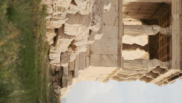 Caryatids statues at Erechtheion temple in Acropolis of Athens, Greece. Erechtheum is an ancient Greek Ionic temple in Greece. Vertical orientation