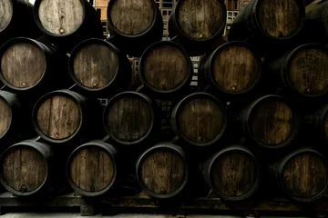 Fotobehang Wine barrels in wine-vaults in order © luciano