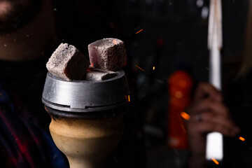 red-hot coals in a hookah bowl sparks