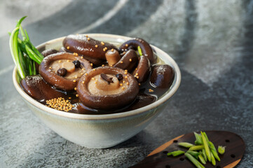 Boiled shiitake marinated with spices close-up. Mushrooms prepared for further cooking