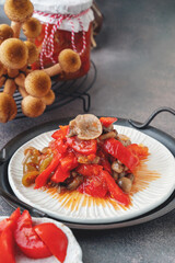 Lecho made of peppers, tomatoes and honey fungus mushroom. Home cooking for winter. Cold appetizer. Preparation for cooking the first course
