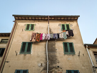Drying laundry at the facade of an oldresidential house in the Tuscany