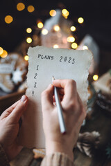 Writing new year resolutions 2025 by hand in December on New Year's Eve. Plan, goals, ideas,...