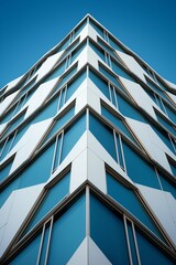 Looking up at the corner of a modern blue and white building with protruding geometric shapes