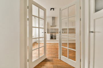 Kitchen seen through open white door