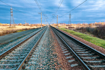 Obraz premium railway, rails and sleepers close-up at sunset under a stormy sky