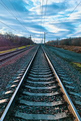Fototapeta premium railway, rails and sleepers close-up at sunset under a stormy sky